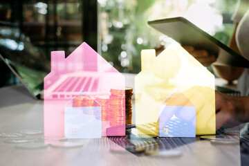 stacking money coins and a house model.save and investment for buy house concept .for the future.save money concept.