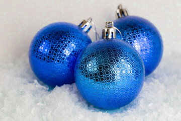Blue christmas balls on the snow