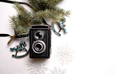 vintage camera and christmas decorations on a white background