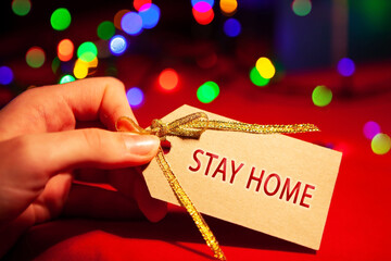 A woman's hand holds a label with text.