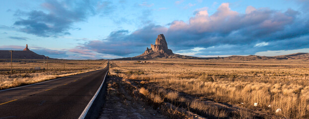 Scenic clouds above a straight road through Navajo Nation