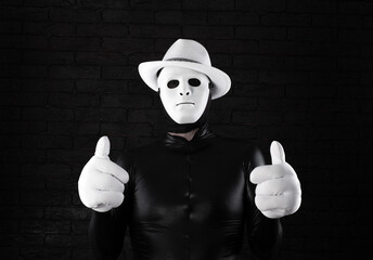 funny mime in a white mask on a black background