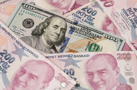 US dollars and Turkish Liras on top of each other completely covering the screen. 1 US dollar being equal to 10 Turkish Liras concept photo shoot