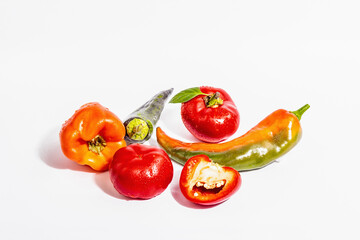 Ripe multicolored peppers isolated on white background