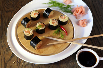 Sushi Set - Different Types of Maki Sushi and Nigiri Sushi. Served on dark wooden table.