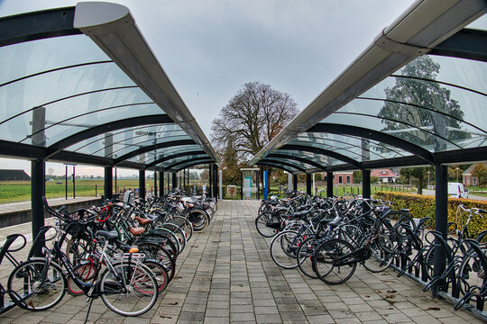 Outdoor bicycle parking at a railway station in a village in the Netherlands. Warffum, province of Groningen
