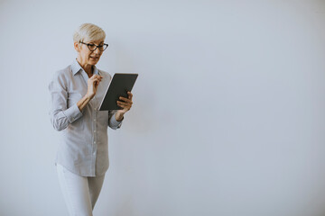 Mature woman using digital tablet in the office