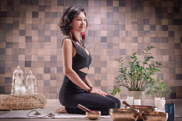 Image of an adult woman in yoga place. Meditation. The concept of yoga and spiritual practices.