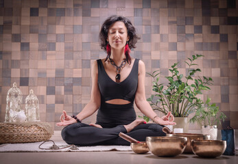 Image of an adult woman in yoga place. Meditation. The concept of yoga and spiritual practices.