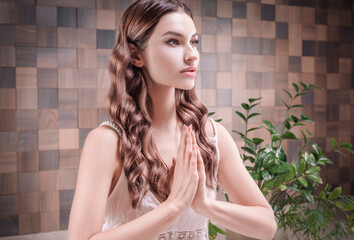 Image of an adult woman in yoga place. Meditation. The concept of yoga and spiritual practices.