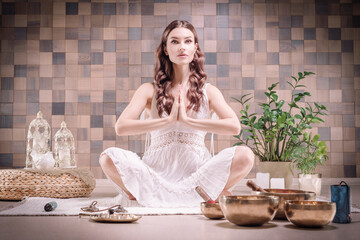 Image of an adult woman in yoga place. Meditation. The concept of yoga and spiritual practices.