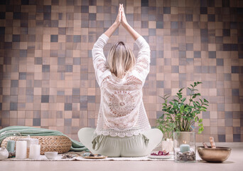 Image of an adult woman in yoga place. Meditation. Back view. The concept of yoga and spiritual...