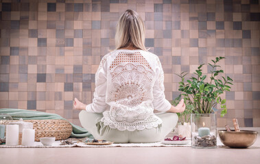 Image of an adult woman in yoga place. Meditation. Back view. The concept of yoga and spiritual...