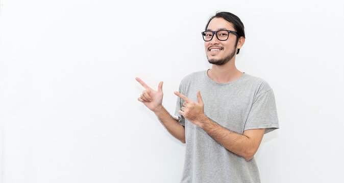 Attractive beautiful positive happy asian man hands point up. Close up portrait asian nerdy man. Handsome nerd asia Japanese guy wearing glasses with big smile isolated on white background.
