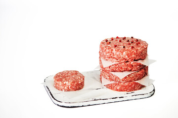 Raw hamburger meat isolated on wooden board on white background