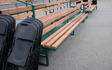 folded chairs and mounted benches for spectators on the street. street performances of speakers and...
