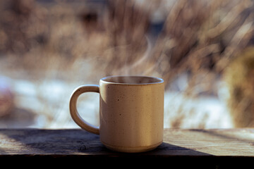 cup of hot coffee outside in the winter