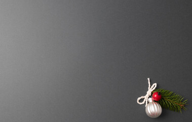 The minimal Christmas Concept is a silver ball and a red berry on a gray background. A greeting card. free space for signature. Top view.