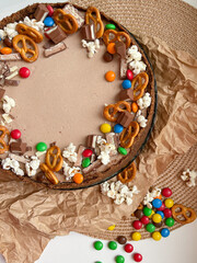 Chocolate cake decorated with colorful dragees and cookies