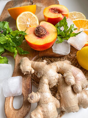 Ginger, peach, lemon, orange, mint, ice cubes - ingredients for juice