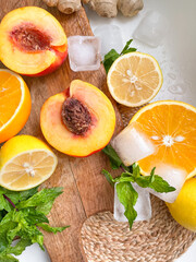 Ginger, peach, lemon, orange, mint, ice cubes - ingredients for juice