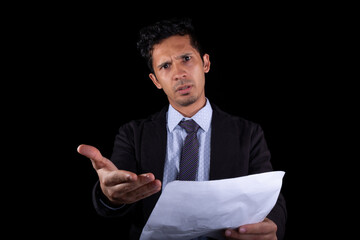 Businessman making paperwork claim and looking at the camera very angry. Young businessman showing...
