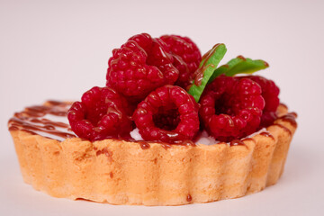 Fresh cake with raspberries in powdered sugar. Dessert in a cafe for breakfast.