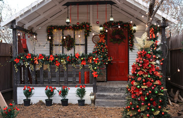 Christmas porch decorated with glowing garlands, Christmas decorations, Christmas wreath on the...