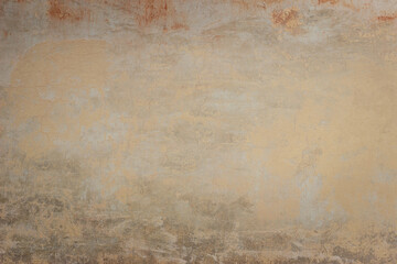 Old ochre concrete wall with different spots and divorces 