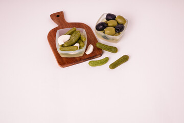 Pickles cucumbers with garlic on a white plate. Russian menu. 