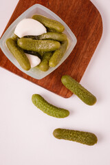 Pickles cucumbers with garlic on a white plate. Russian menu. 