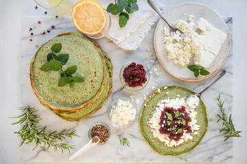 Close-up of pink pancakes with beetroot and feta, and green pancakes with spinach