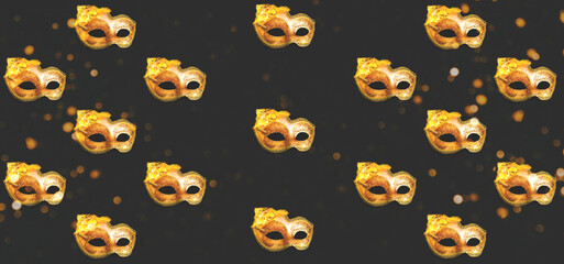 Pattern from Golden Carnival mask on dark background with sparkles. Mardi Gras concept. Design for festive wrapping paper.