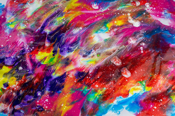 Abstract and organic texture made with acrylic paint of various colors that simulates a unique and creative universe