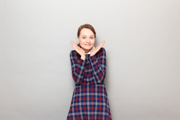 Portrait of happy overjoyed young woman smiling and raising hands up