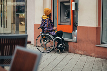 Woman with disability using credit card and atm machine