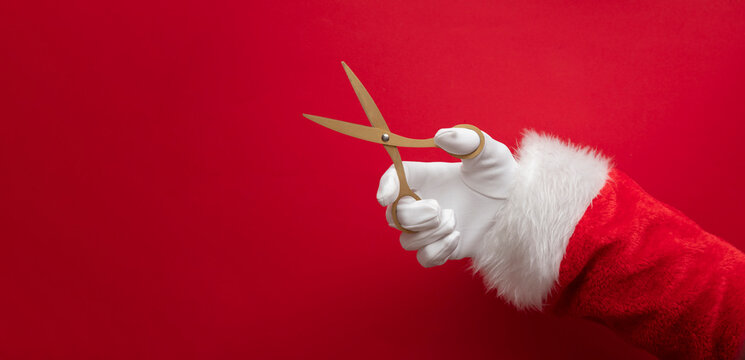 Father Christmas with gold scissors. Festive grand opening background