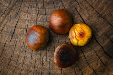 roasted chestnuts on a wooden cutting board