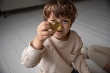 a child shows a bitcoin 