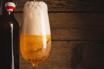 mug of light beer on a wooden background. foamy beer. cold light beer