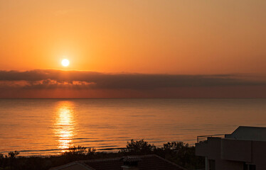 A golden sunrise on the beach, a summer day in the Mediterranean