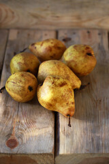 Ripe yellow pears on a wooden surface. Late autumn pears.