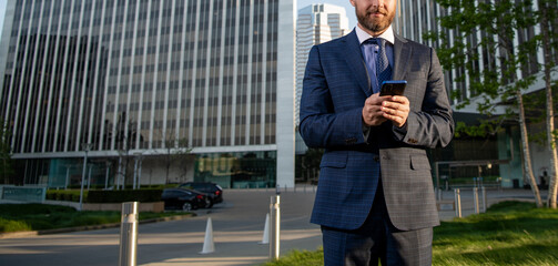 cropped entrepreneur in businesslike suit reply email outside the office, copy space, negotiation