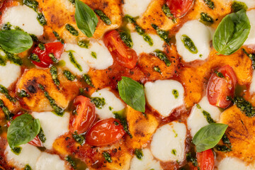 Background of appetizing margarita pizza close up filling the frame.