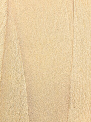 Close up texture of sand with lines made by wind and ocean