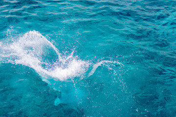 Splashes of blue, sea water with foam bubbles. A splash of nature on a summer day. blue sea background with splashing water. sea vacation concept.