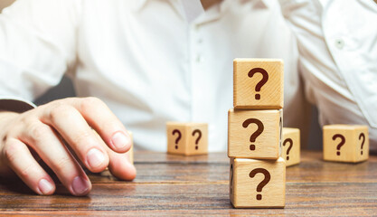 Man is in thought and blocks with questions. Pondering the problem, gathering all the facts. Make...