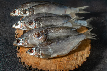 Ready-made silver bream fish, dried, dry, salted, appetizing laid out on a dark background. Catch river, fishing.