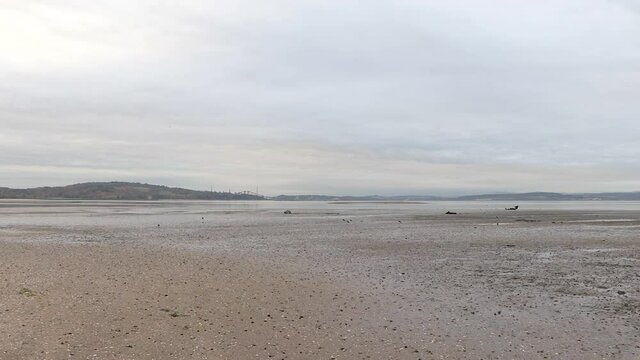Evening walk at Cramond Beach at low tide. Cramond, Edinburgh, UK