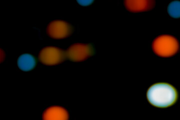 Abstract illustration of colorful blurred lights background, bokeh effect, on black background